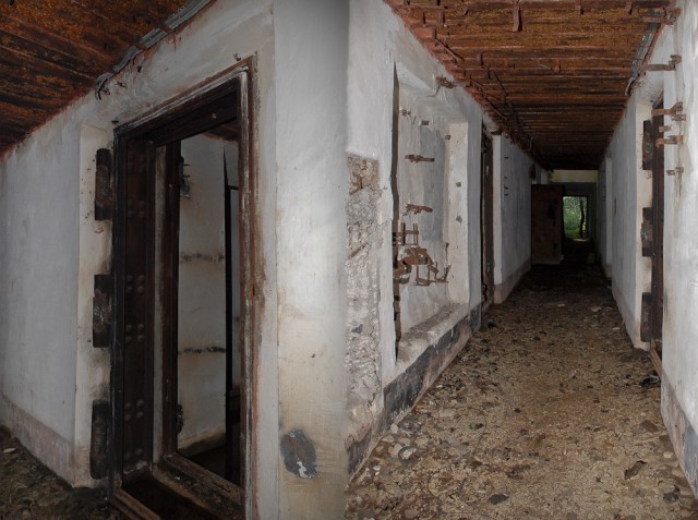 Kairėje - sprogstamųjų užtaisų sandėlio durų liekanos, dešinėje centrinis koridorius (kairiau durys į įgulos patalpas, kiek toliau - į katilinę)